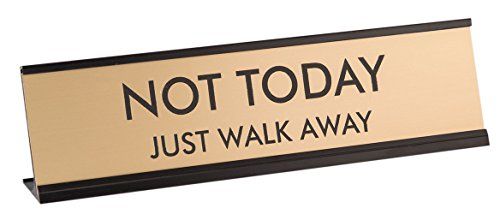 A humorous desk sign or plaque.